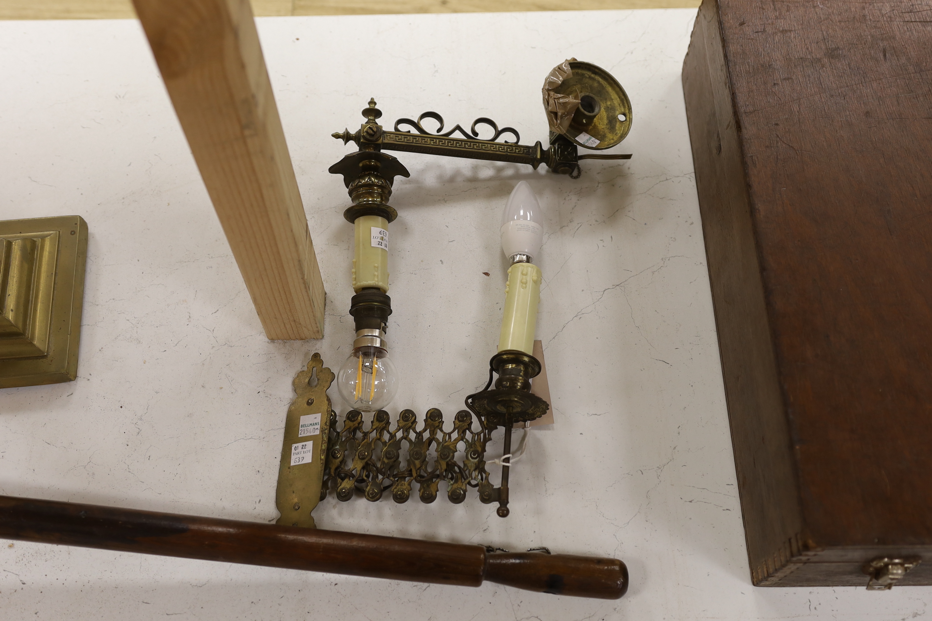 A brass Corinthian column oil lamp, two brass wall sconces and an 1823 copper saucepan